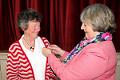 Merrill Bayley receives the Presidents Badge from Julie